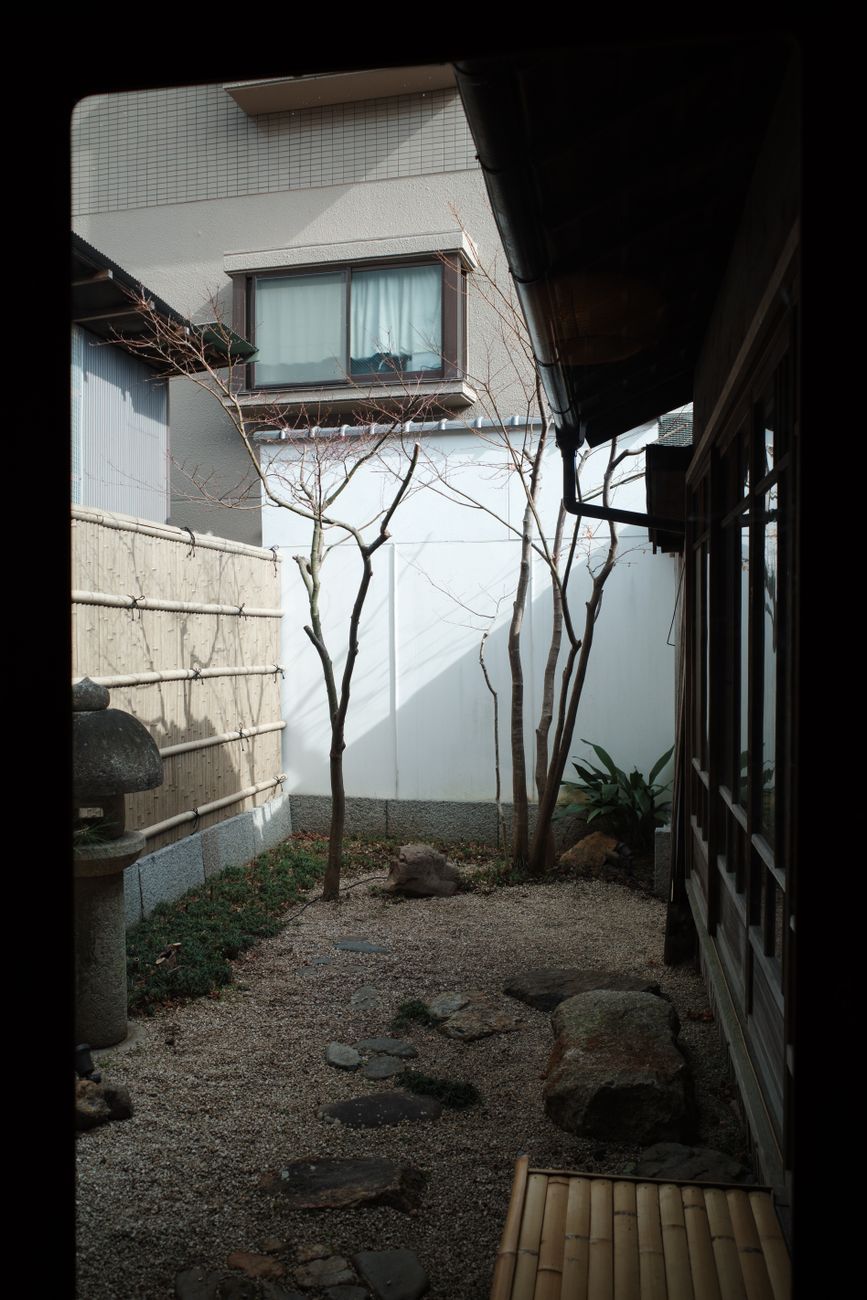 Traditional Japanese wooden ryokan hallway overlooking courtyard garden